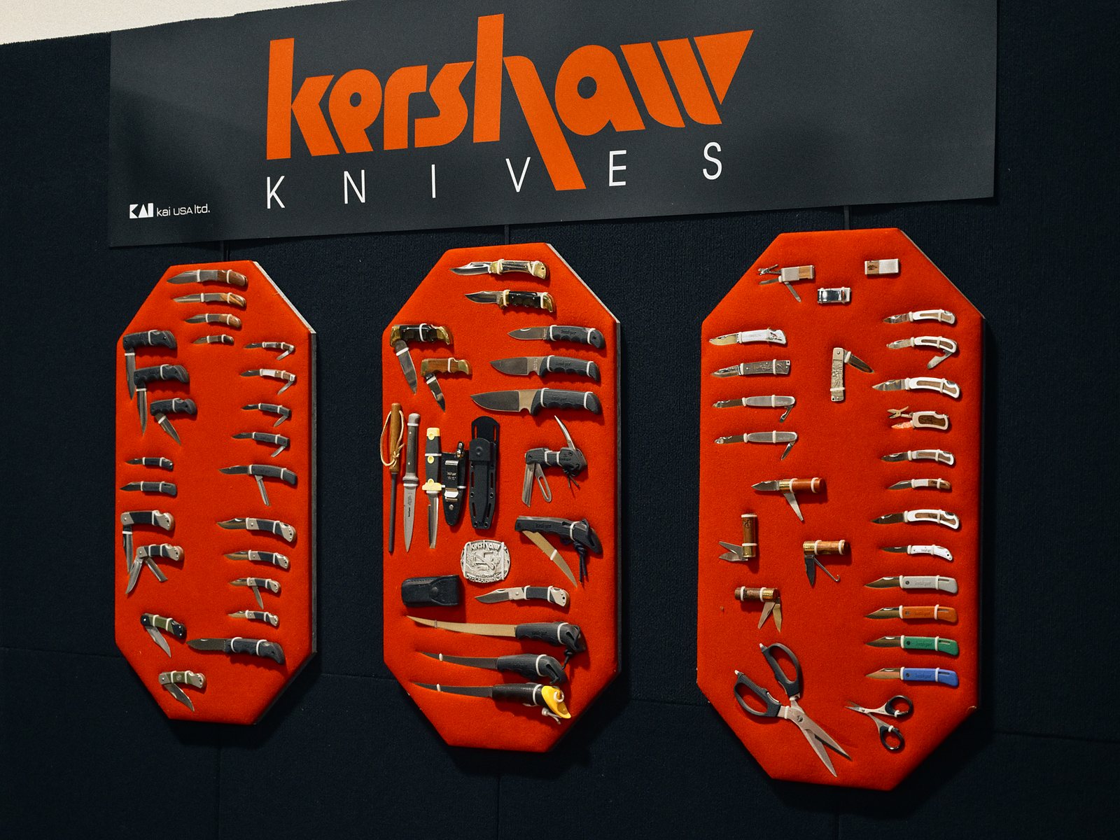 Kershaw Knives booth: three red boards of Kershaw knives under the company sign