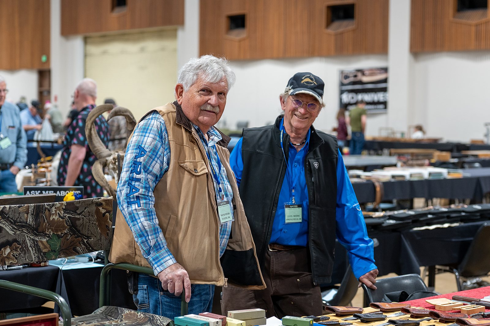 Two OKCA members smiling at their table at the 2026 show